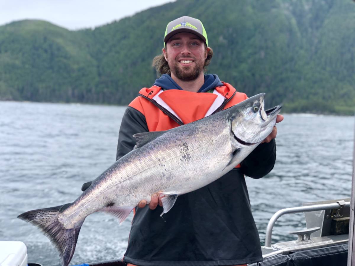 AU Captain Tyler Floding holds an Alaskan salmon