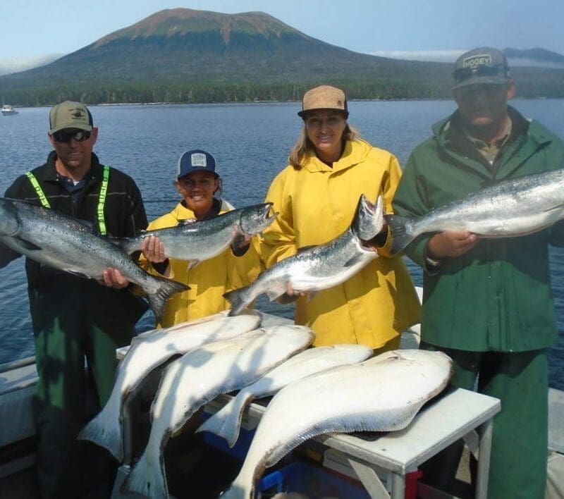 Angling Unlimited guests hold salmon and halibut