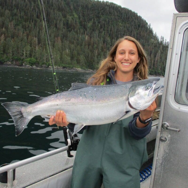 Angling Unlimited guest holds up a king salmon