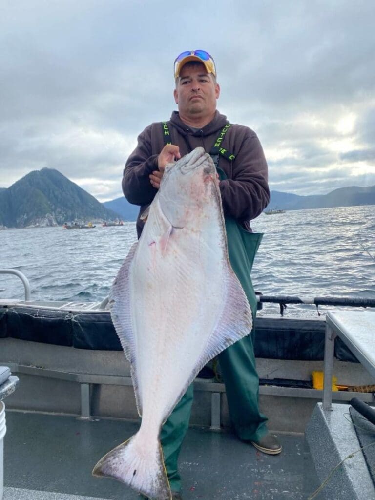 Chad Cottet with a big halibut caught on a salmon rod with Angling Unlimited