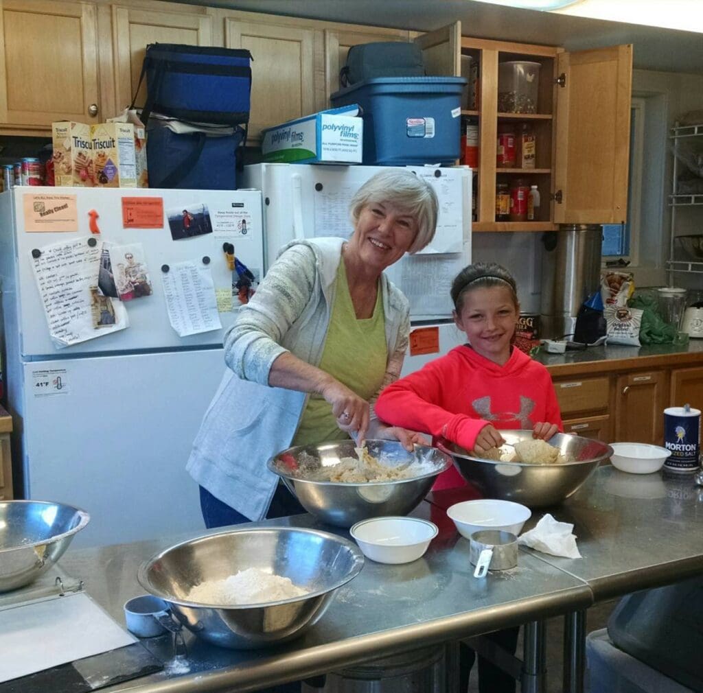 Grandma Sue and Grace working together in the AU kitchen