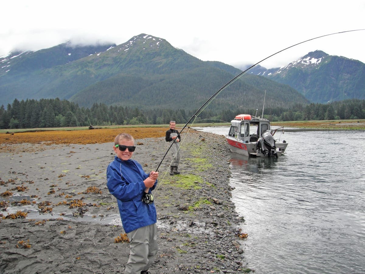 Young Angling Unlimited guest fishes from the shore in Sitka, Alaska