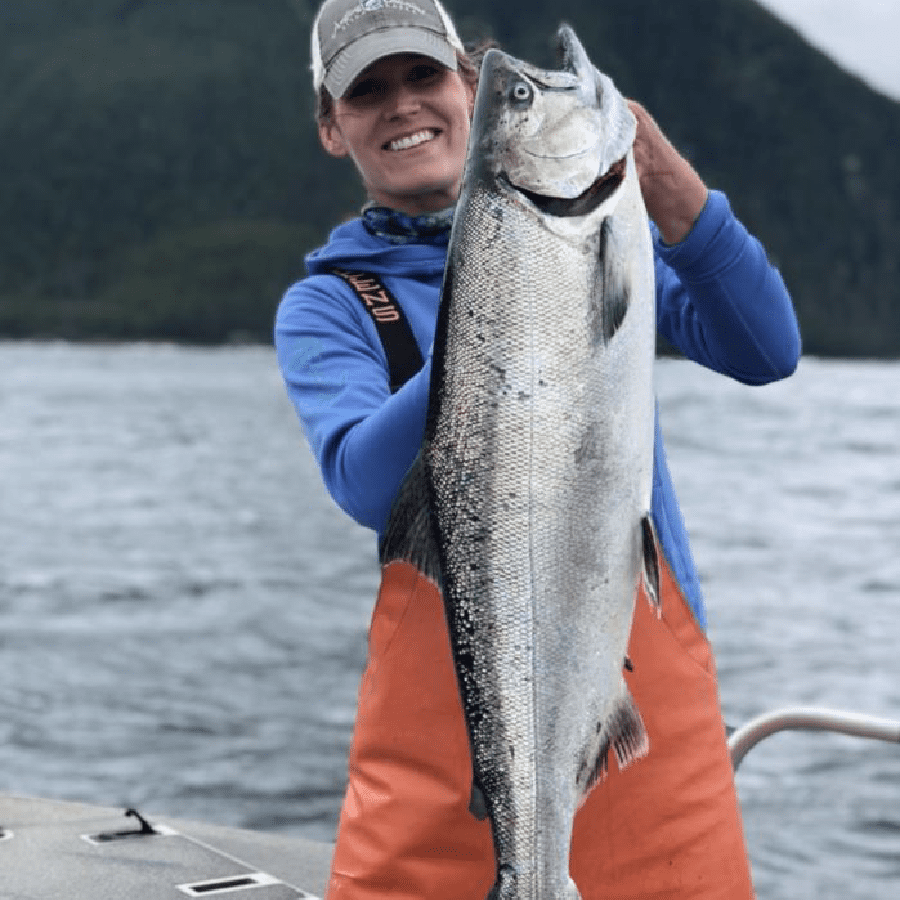 Angling Unlimited crew member Sarah Farber holds an alaskan salmon in Sitka, Alaska