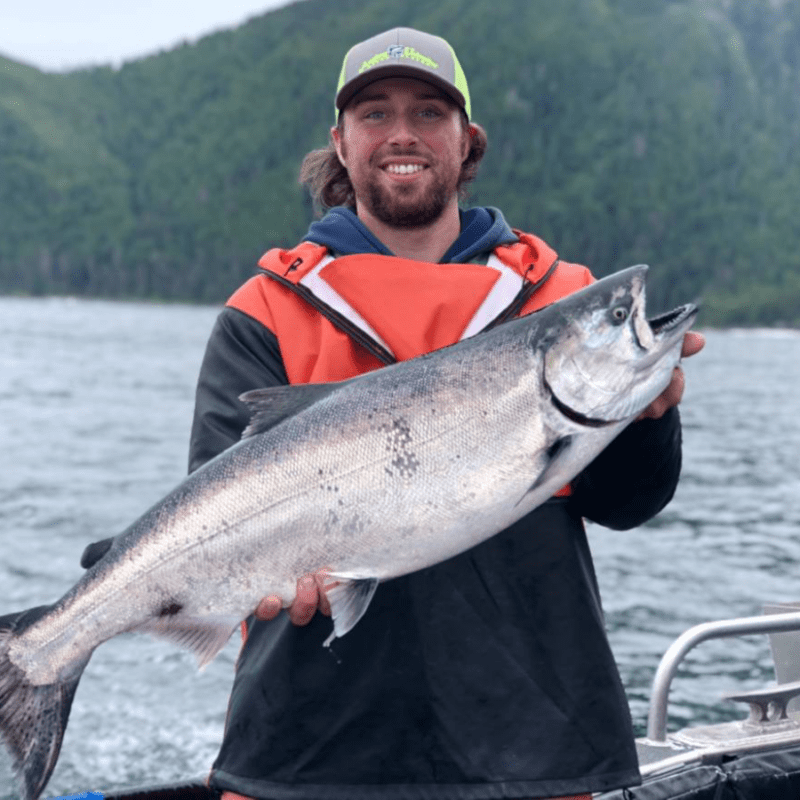 Angling Unlimited crew member Tyler Floding holds a salmon