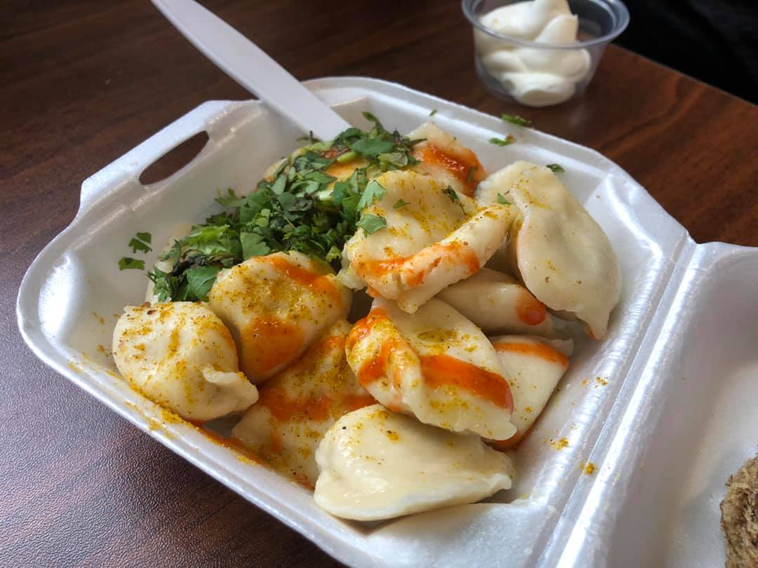 Dumplings in a white styrofoam to-go container
