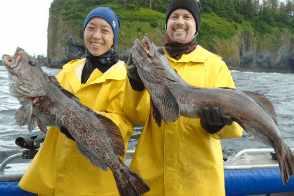 Two Angling Unlimited guests hold Lingcod that were caught in Sitka, Alaska